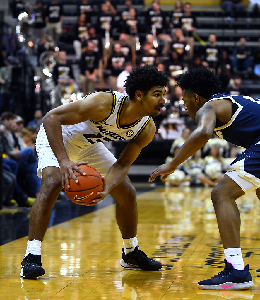 Missouri guard Mark Smith locks eyes with Charleston Southern guard Travis Anderson